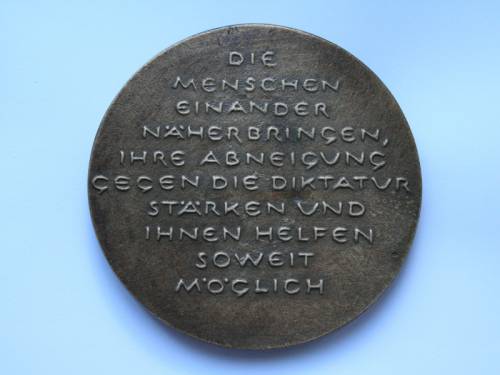 Alte Münze auf der steht "Die Menschen einander näherbringen, ihre Abneigung gegen die Diktatur stärken und ihnen helfen soweit möglich"